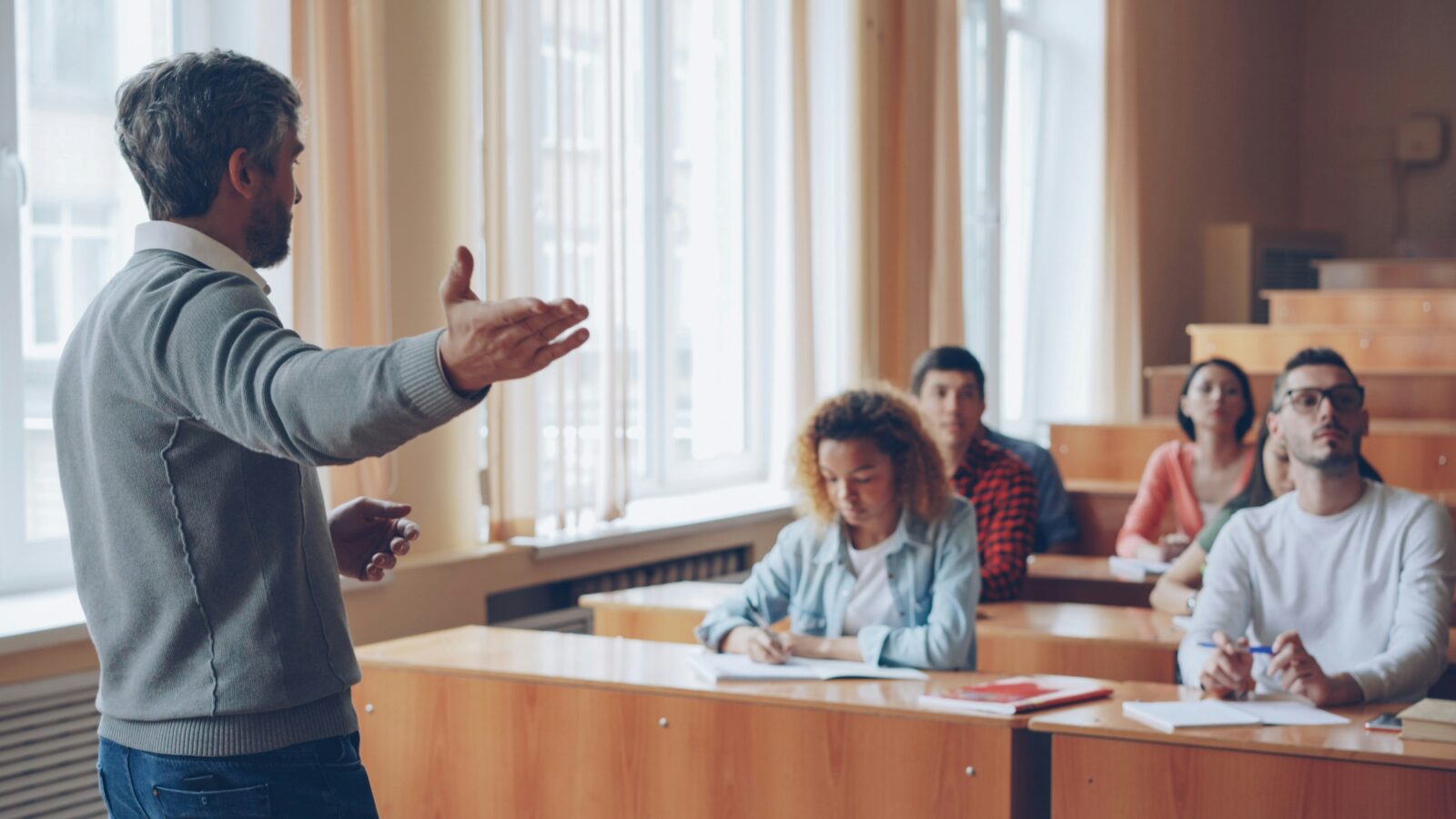 Professor lecturing to a class in a lecture hall. Photo by Vitaly Gariev