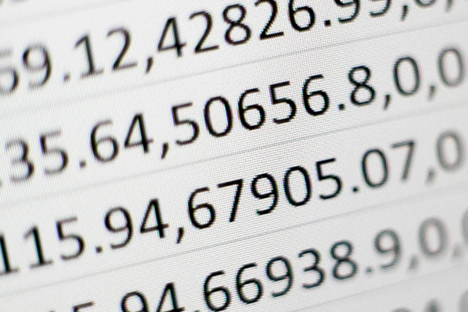 Picture of rows of numbers. Photo by Mika Baumeister on Unsplash.
